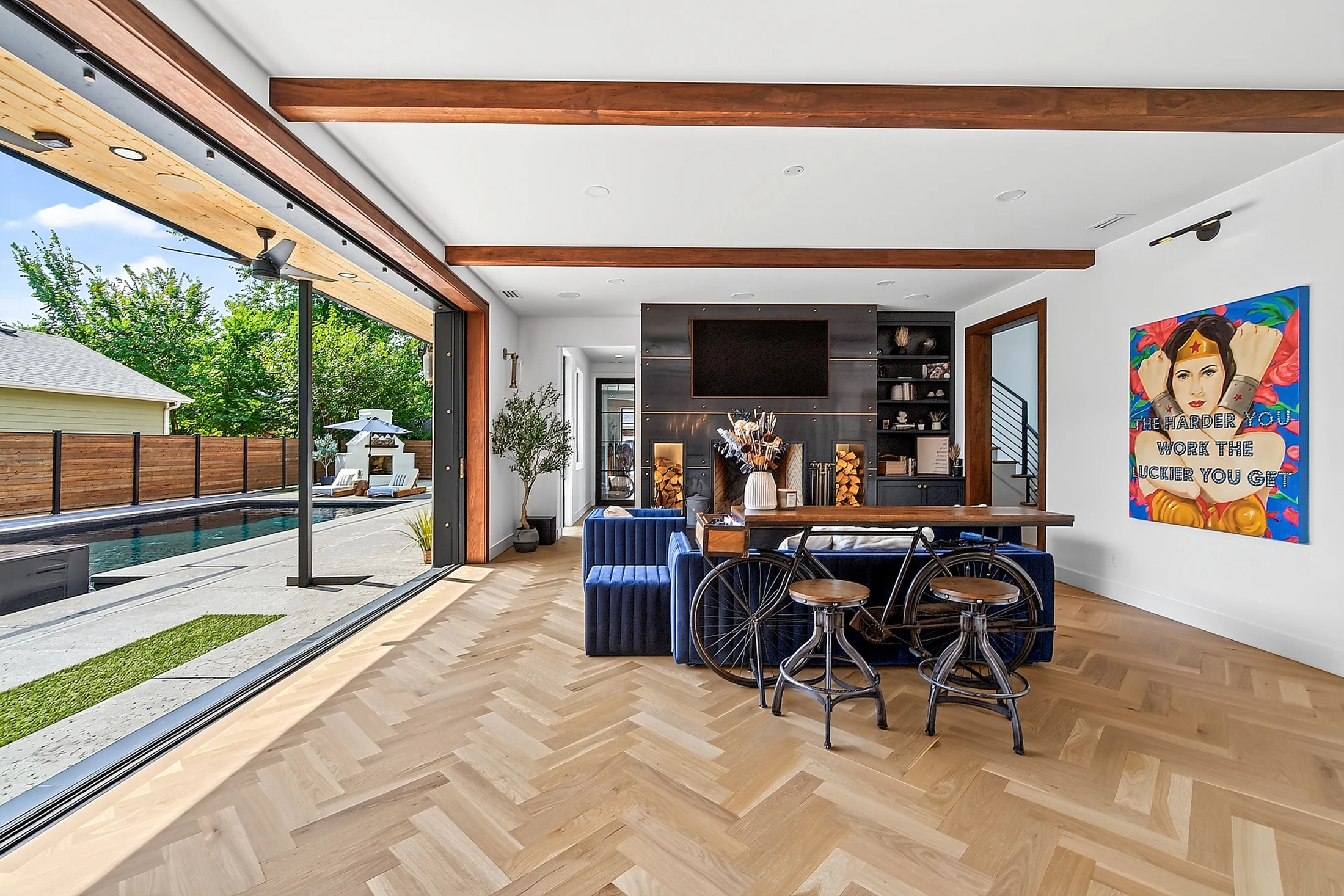 The disappearing steel wall connects the great room and pool